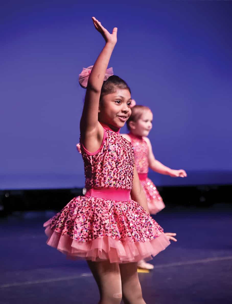 young dancers in a pink costumes on stage